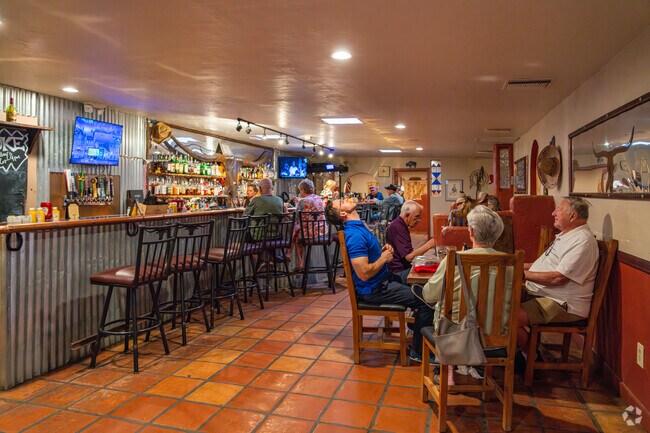 Inside the Longhorn Grill and Saloon, guests enjoy a relaxed, rustic atmosphere complete with Southwestern decor, a full-service bar, and comfortable dining areas in Green Valley.