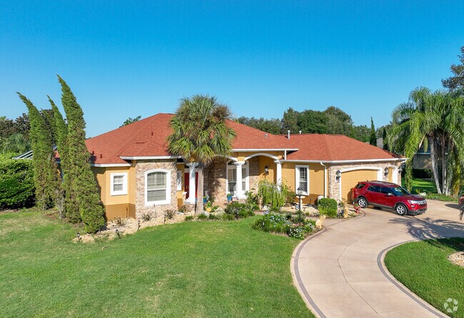 Harmeswood of Belle Aire has well manicured lawns and palm trees throughout.