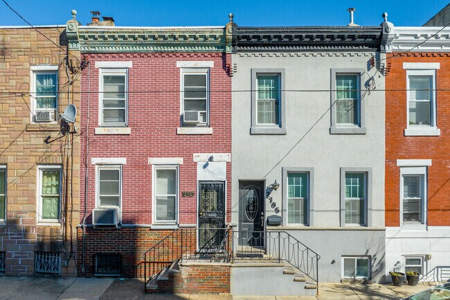 Brick row homes sit next to stucco exteriors on the streets of Whitman.