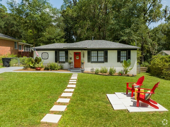 This pretty brick ranch has a simple seating area in the sunshine.