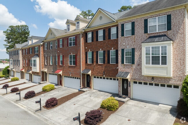 Elegant brick townhomes in Victory offer modern, multi-level living with attached garages, perfect for residents seeking both space and convenience in a walkable neighborhood.