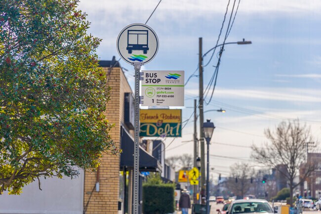 Commuters gather at the bustling bus stop in Colonial Place.