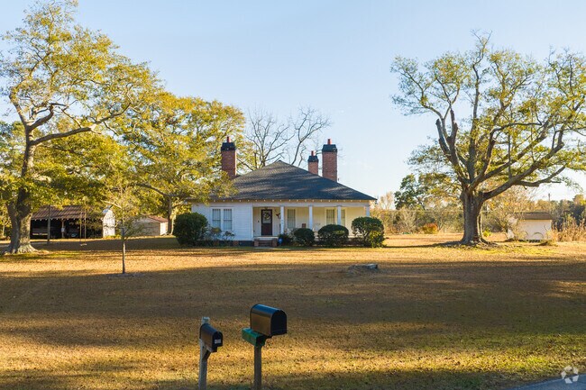 Bowdon homes, like this white wooden clapboard house, have large lots with detached structures.