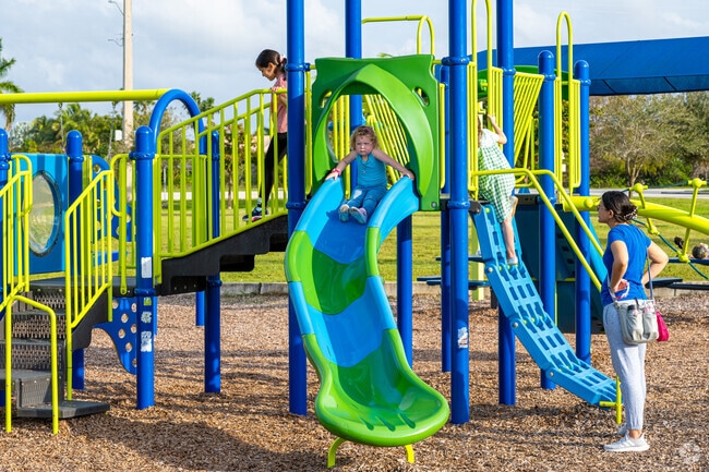 Kids enjoy the bright slide at Harbour Lake Park in Cooper City’s family-friendly setting.
