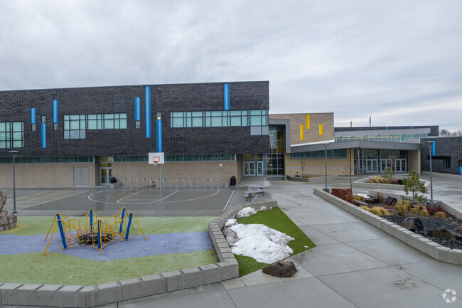 Glover Middle School features a modern playground in front of the building.