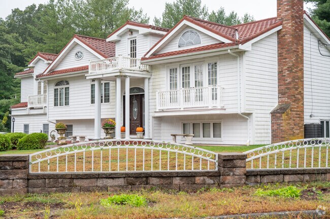 A red Spanish tile roof sets this home apart from other homes in North Apponagansett.