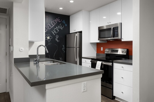 Design Package II Kitchen with quartz countertops stainless steel appliances and hard surface flooring