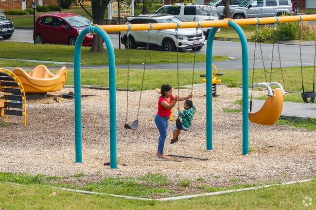 Families enjoy the swings and much more at the playground at Bowman Park.
