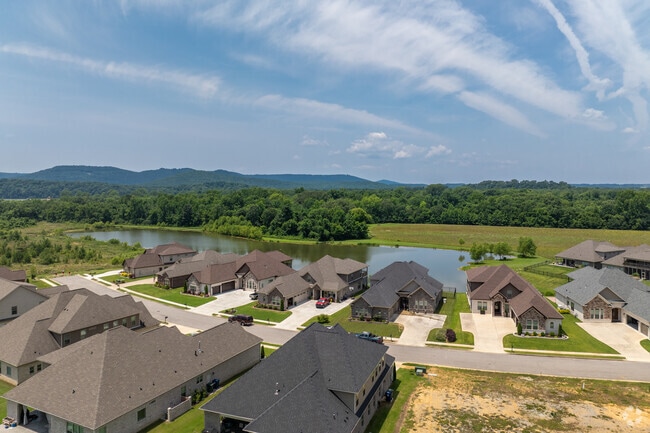 A lake sits comfortably behind a beautiful suburb.