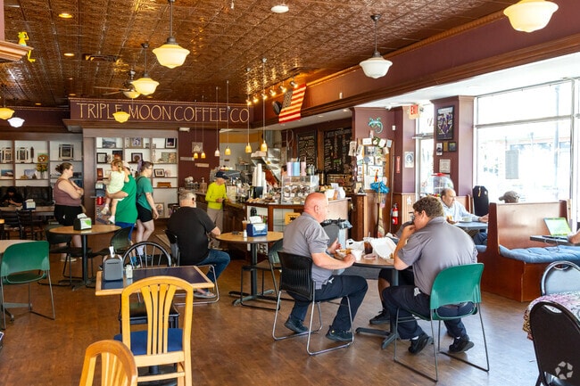 Triple Moon offers a cozy atmosphere with wood flooring, copper ceilings, and a menu featuring items like chicken and egg salad sandwiches, wraps, and Italian subs.