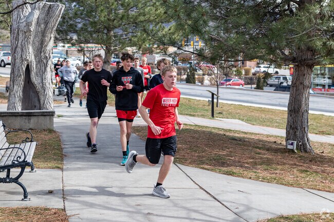 Weber High’s track team runs through the Harrisville neighborhood.