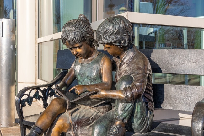A bronze statue of children reading welcomes you to the Orland Park Public Library.
