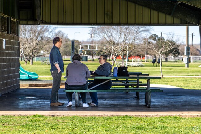Friends chat at one of Maclean Park's many picnic areas in Lake Jackson.