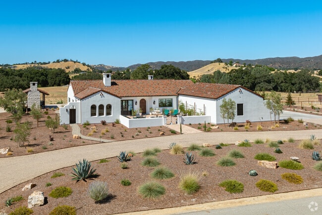 A newly built Spanish style home sits on a lot overlooking the rolling hills of Garden Farms.
