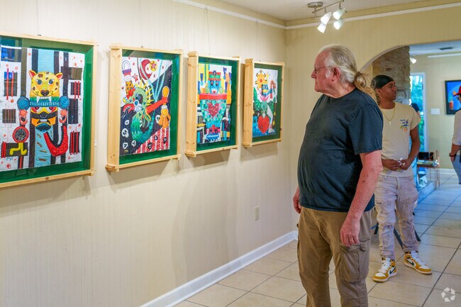 A Casselberry resident enjoys viewing artwork at the Latin Jazz and Art Festival.