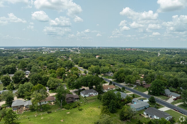 Shepard Boulevard is a neighborhood characterized by a dense canopy of trees and asphalt roads.