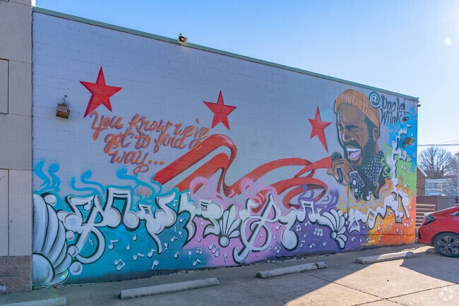 Full-wall murals stretch along the colorful streets of Benning.
