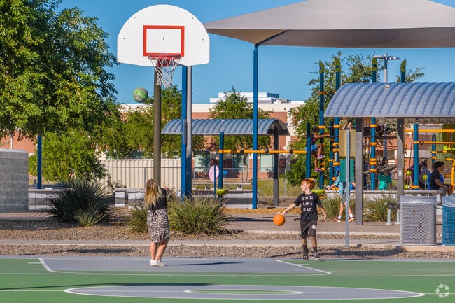 Basketball enthusiasts gather for friendly games at Camino A Lago Park in Peoria.