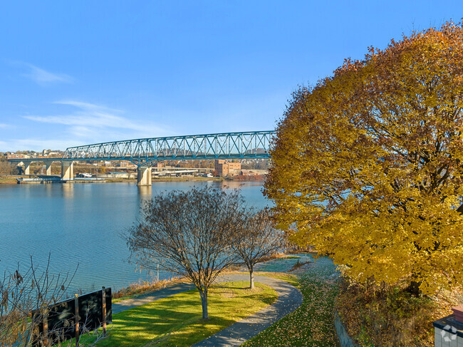 The Rochester-Monaca Bridge is seen beyond the fall colors in Monaca Riverfront Park.