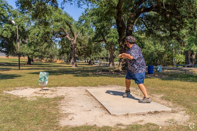 A Heymann Park resident enjoys a game of disk golf.