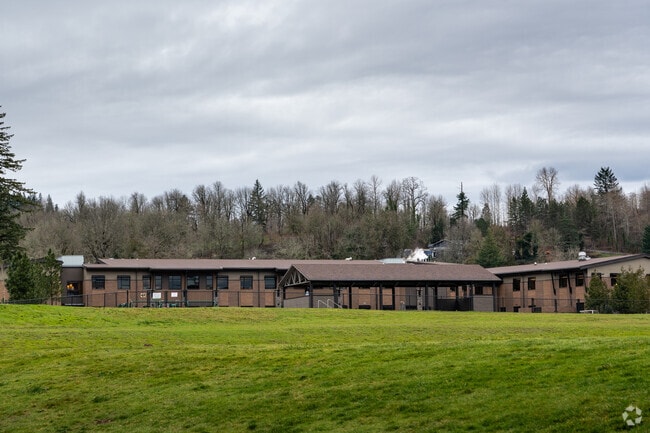 The back of the campus features a sports field and playground.