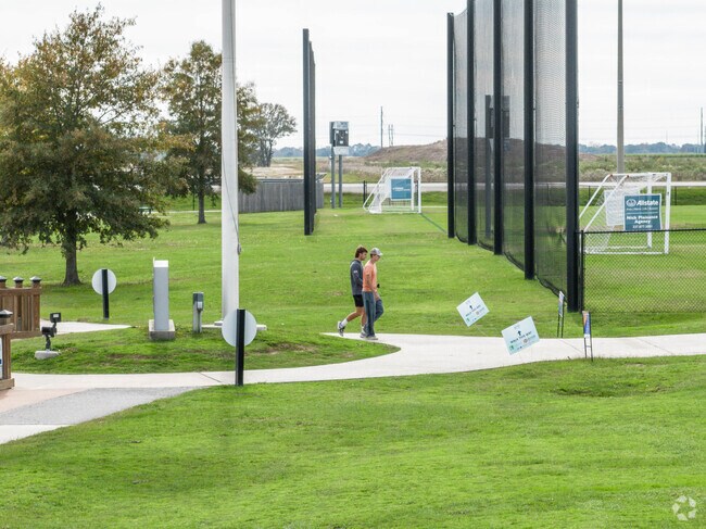 A couple of friends enjoy a stroll along one of Youngsville Sports Complex's many trails.