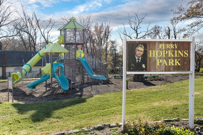 Perry Hopkins Park Entrance Signage with a view of playground in the background.