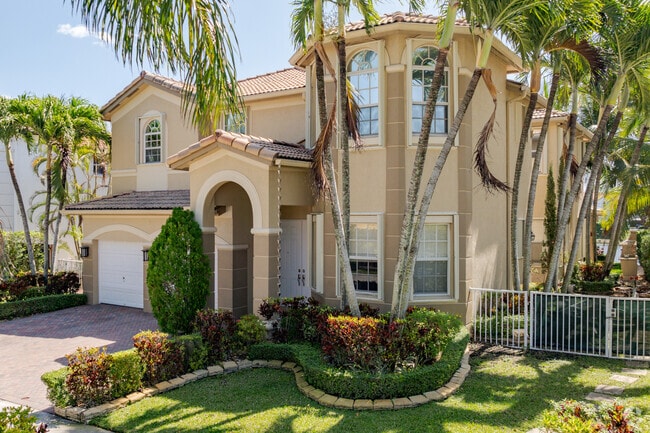 Many of the Island of Doral single family homes offer lush landscaping and car garages with AC.