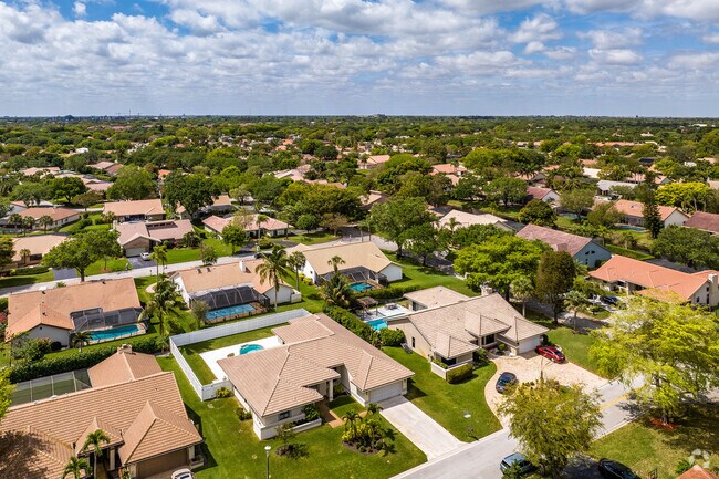 The well maintained Pine Ridge neighborhood is surrounded by lush greenery and quiet streets.