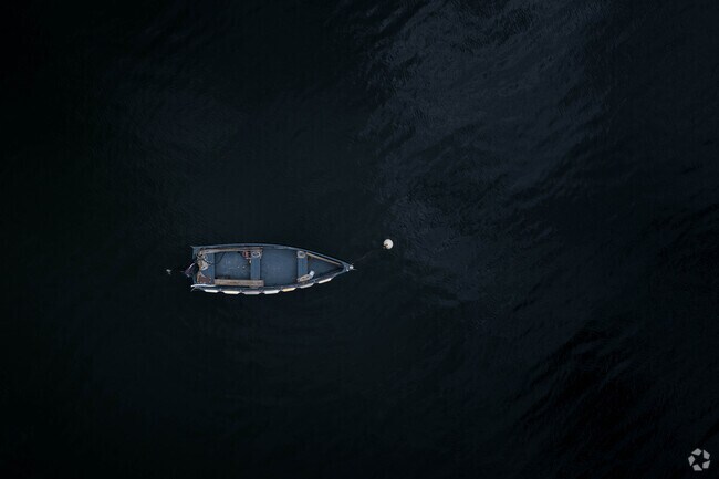A beautiful wooden row boat floats gently in the cove at Cove Neck.