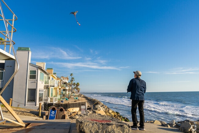 This local is enjoying flying his dragon kite on the beach near Fire Mountain.