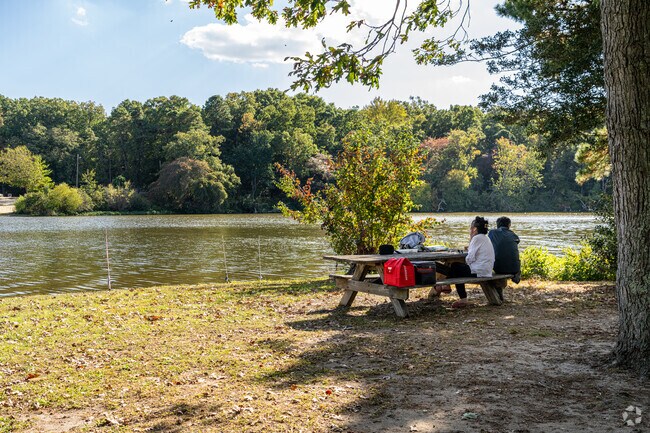 A couple enjoys a picnic lunch while watching their rods at Sunset Lake near Hopewell Township.