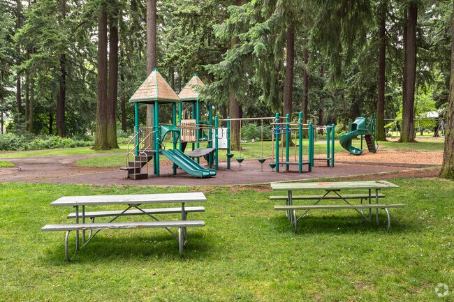 Picnic tables near the shady playground at Alberta Park.