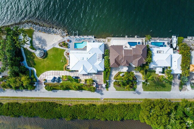 A top-down view reveals waterfront homes along the canals in Gables By The Sea.