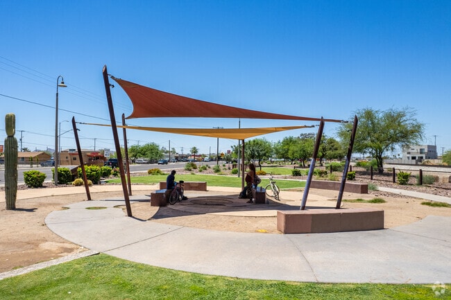Locals gather under shaded trees at Old Town’s walkable Dessie Lorenz Plaza.