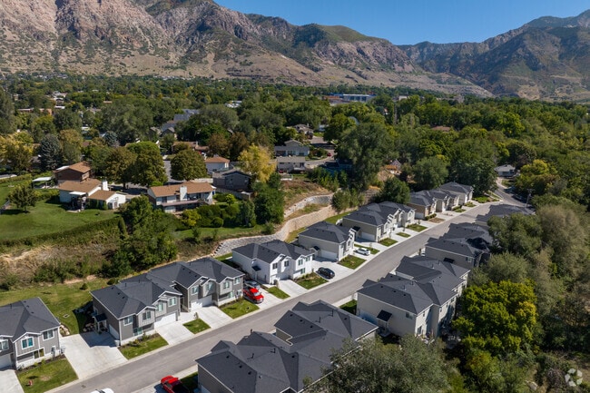 A row of new two-story homes lines this street near the mountains.
