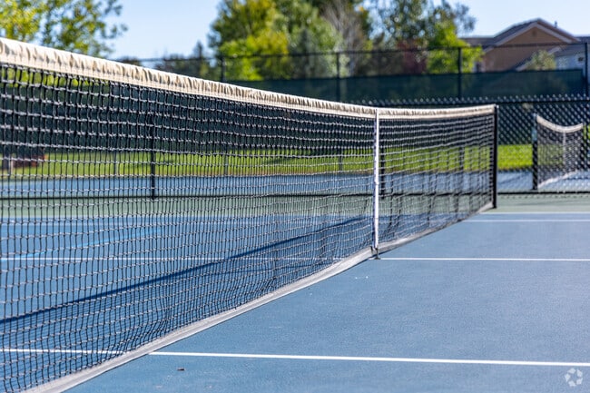 Residents in The Farm-Arapahoe play tennis at the public courts in Central Park.