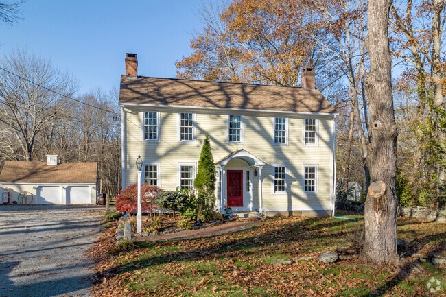 Large Federal-style homes sit beneath old trees in Scituate, Rhode Island.