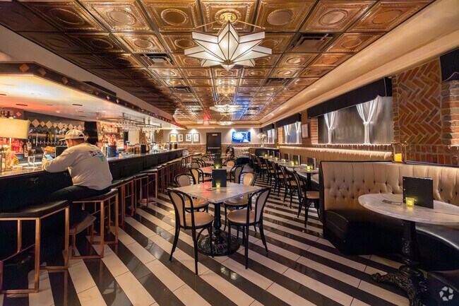 Inside The Cellar Bar, striped floors and vintage lighting set a moody vibe near Silver Hill.