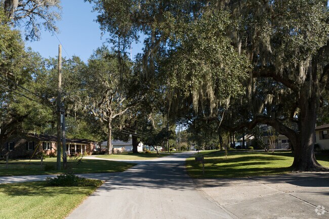 The quiet streets of Sans Souci are shaded with large trees.