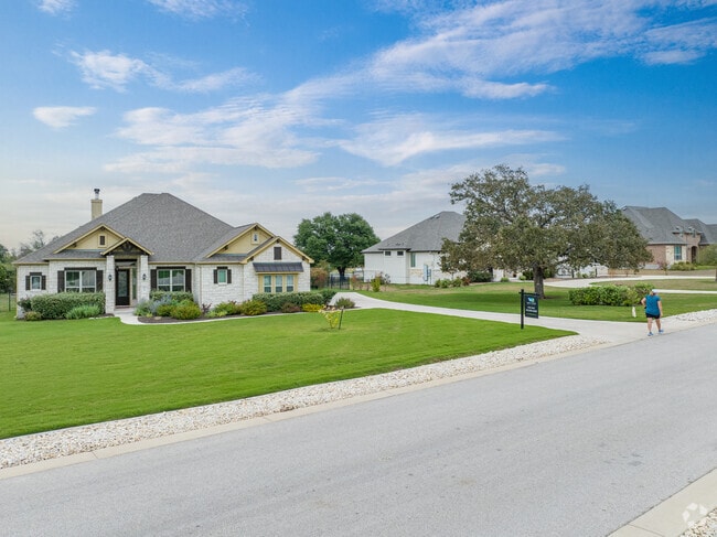 In Liberty Hill, wide streets and mature trees complement brick and stone facade homes.