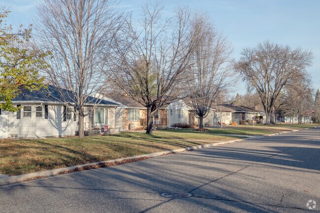 A row of ranch style homes graces a street in Colonial Gardens with its symmetry.