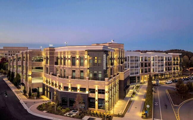 Apartment Building Featuring Multi-Level Parking and Corner Retail Space