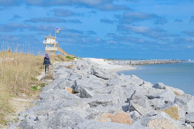 Walk along the nature trail to the observation tower at Lighthouse Point Park.