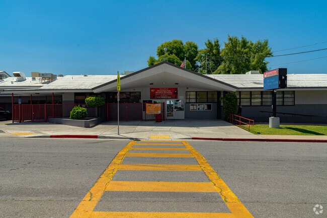 The entrance to the school is centered straight in alignment with the cross walk.