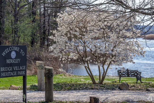 A bench and blooming trees truly welcome you to Berkley at the Berkley Village Heritage Park.