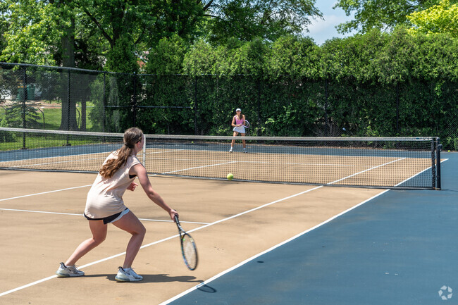 Two girls play tennis at Lemont High School's tennis courts in Hastings.