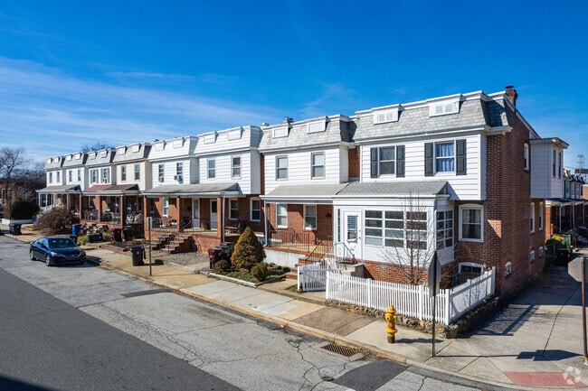 Many Flats rowhomes feature porches along tree-lined streets.