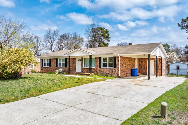 A brick ranch home in Seventy-First includes a covered carport.