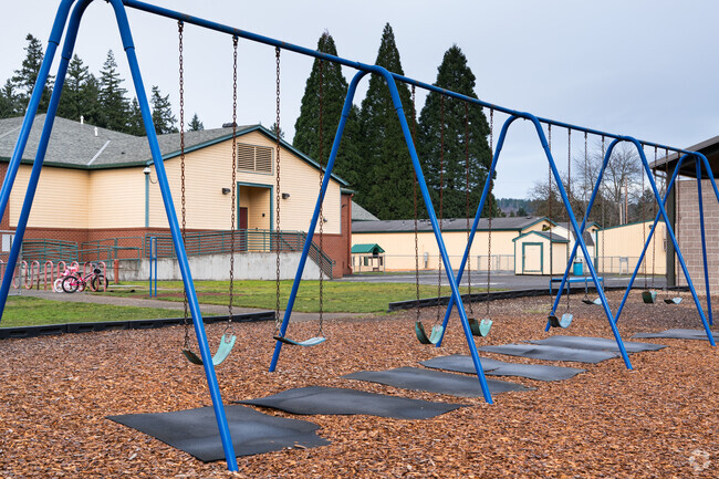 Swing sets sit next to the play structure behind Hathaway Elementary School.